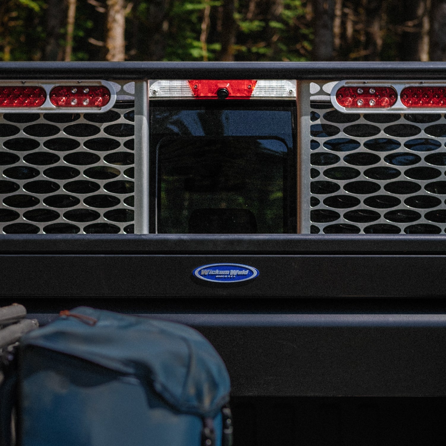 Truckbed with a black crossbox and Wickum rack