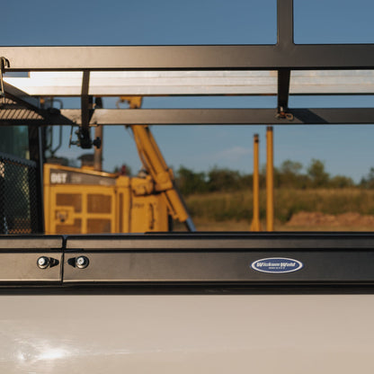 Side saddle crossbox on truck bed with construction vehicle in the background