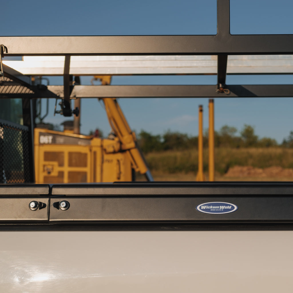 Maverick Crossbox side saddled on a white truck with construction vehicles in the background